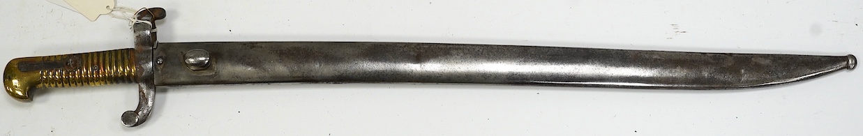 An 1855 French bayonet in its scabbard. Condition - good